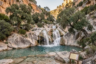 Cascade de la Vis dans les gorges du Gard avec panneau de réglementation d'accès et baignade naturelle en eau turquoise